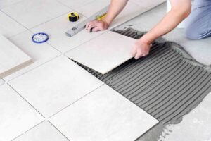 imgi_155_homeguide-worker-installing-ceramic-tile-flooring